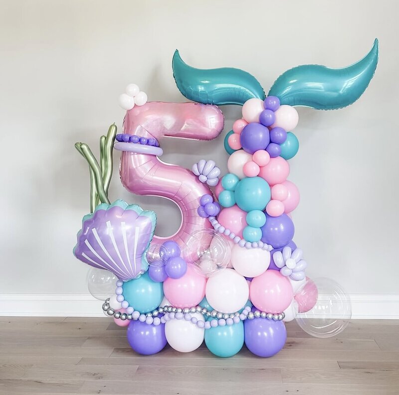 Mermaid themed balloon stack with a number balloon in pink, white, and purple