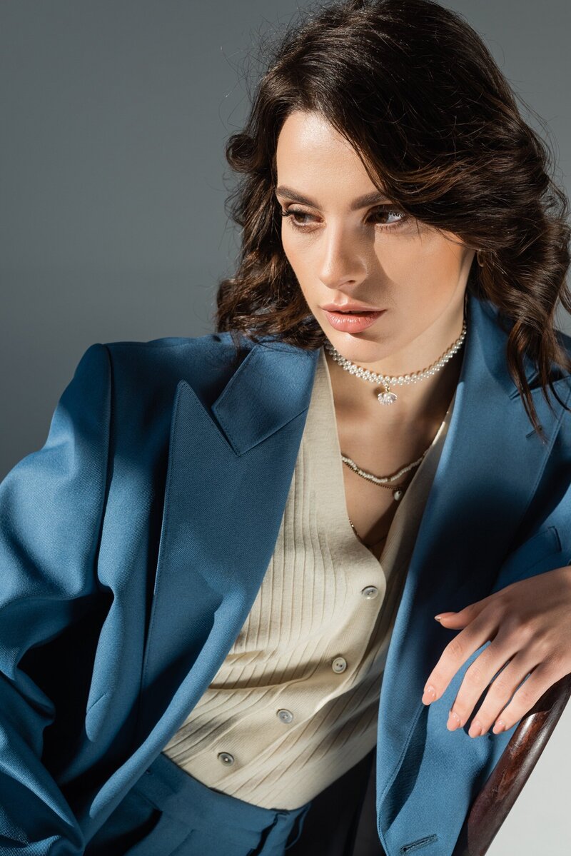 woman sitting in blue suit editorial