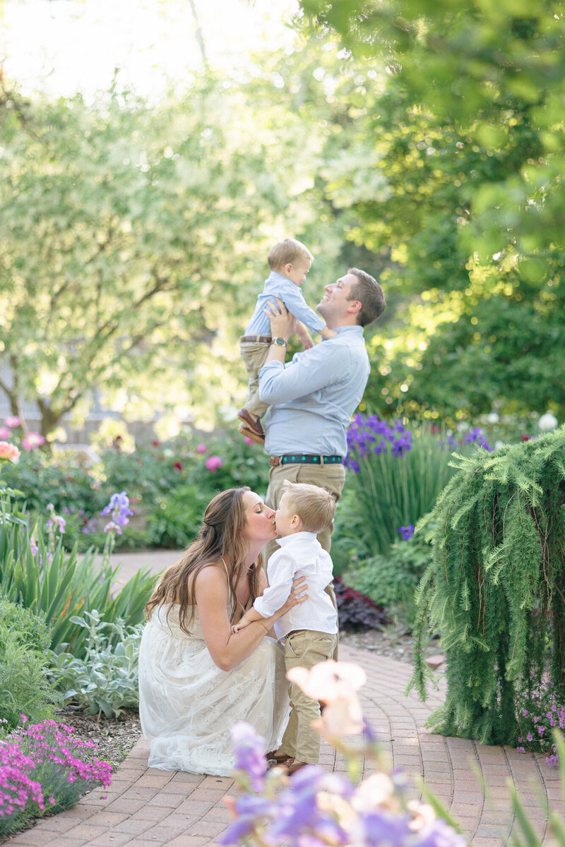 Family of four playing in a garden in louisville kentucky during their family portrait session