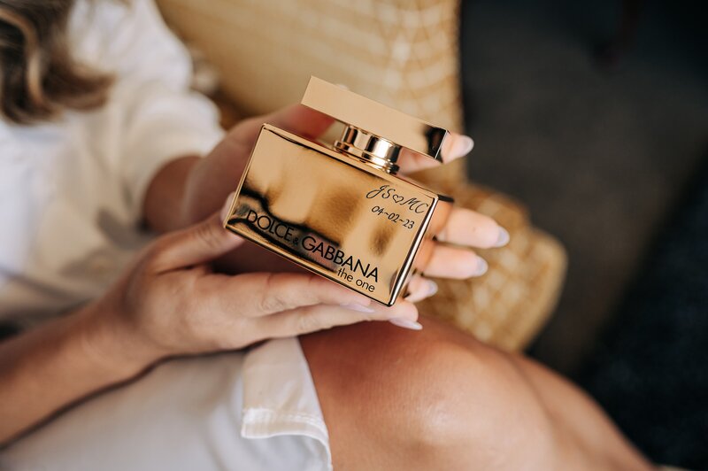 personalised engraved dolce and gabbana perfume in a brides hands as part of her wedding details