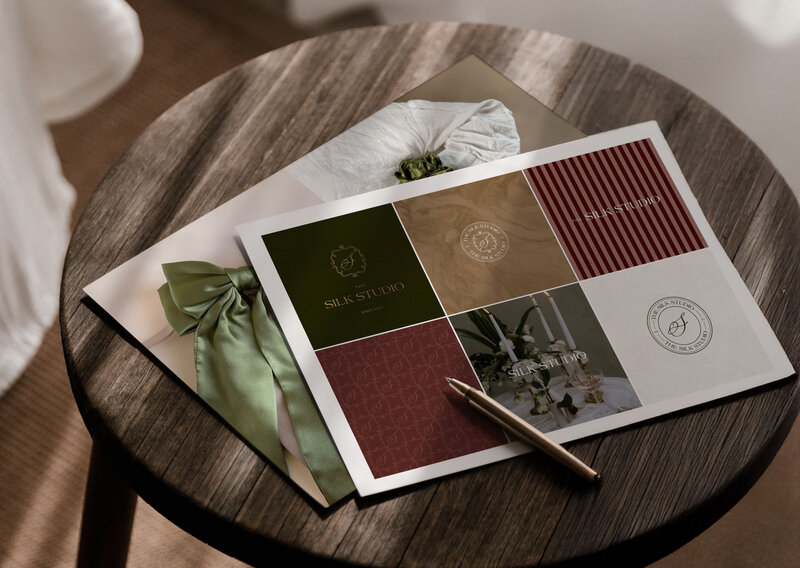 Flatlay of The Silk Studio brand elements printed on paper, showing colour, logo and texture details