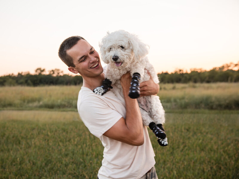 man holding dog and smiling