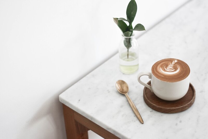 boho style coffee shop with lots of wood and green plant everywhere