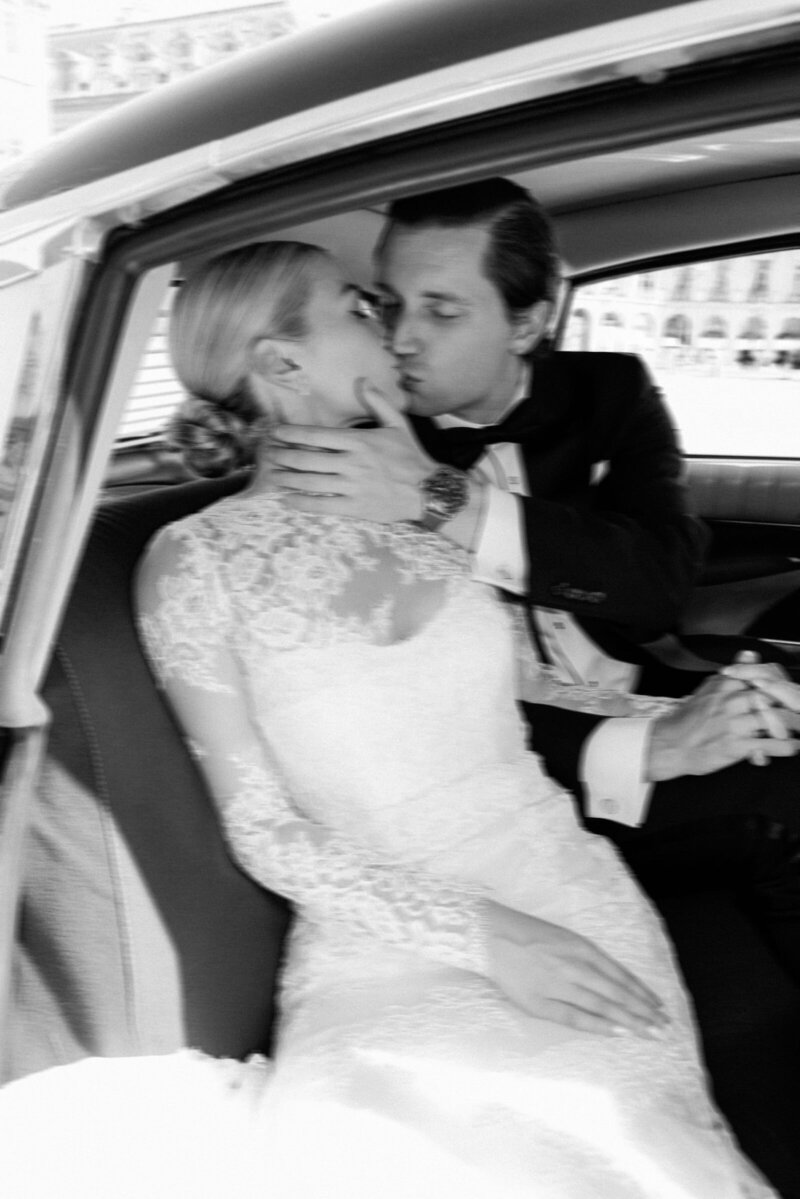 Couple kissing in a vintage car.
