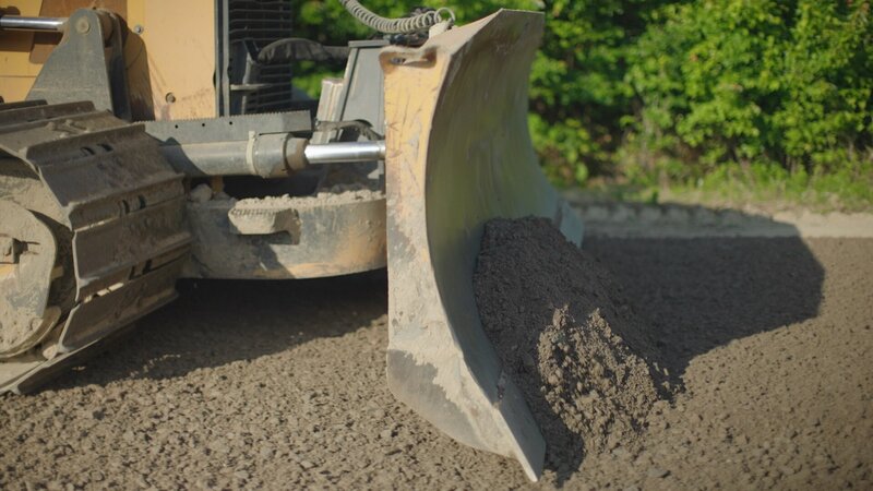 bulldozer pushing dirt on job site