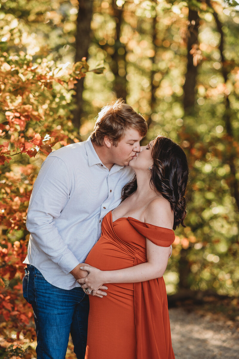 Expectant parents pose for Fall Maternity Photoshoot on the Blue Ridge Parkway in Asheville, NC.