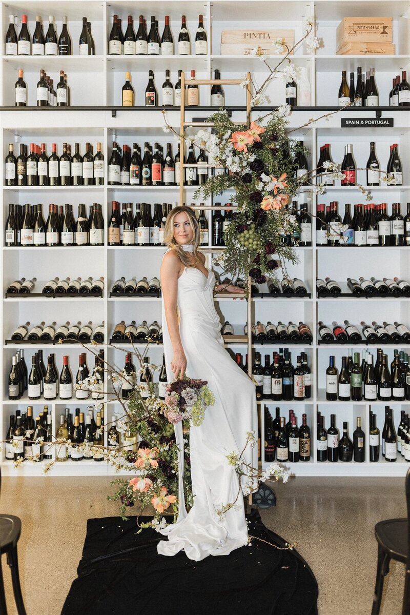 Spring floral installation on wine library ladder with tulips and grapes