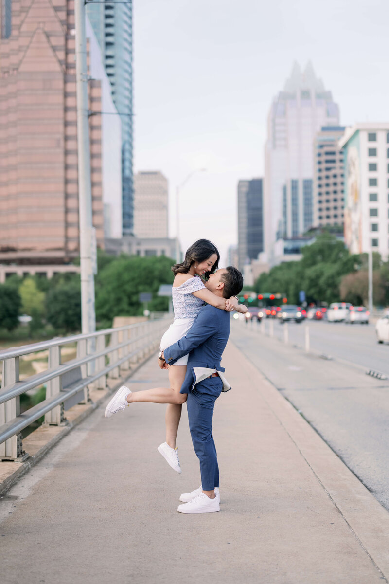 image of a man lifting her woman up at South Congress Bat Bridge