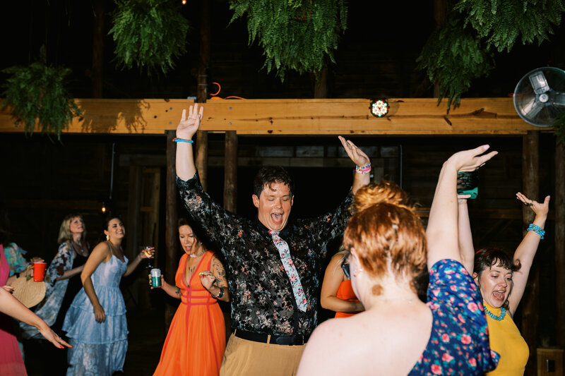 Guests dance with excitement during the reception at Paint Rock Farm with accommodations on site in North Carolina, by photographer Megan Lynn of My Sun and Stars Co.