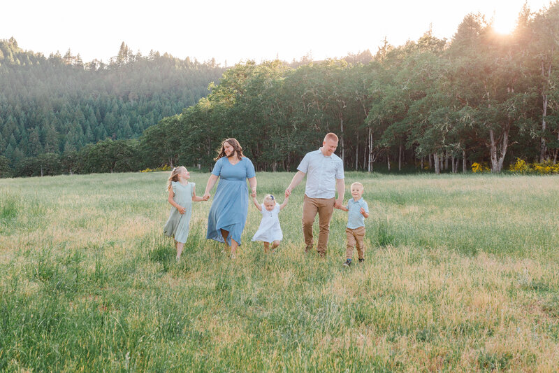 family smiling together in a flower field in Roseburg