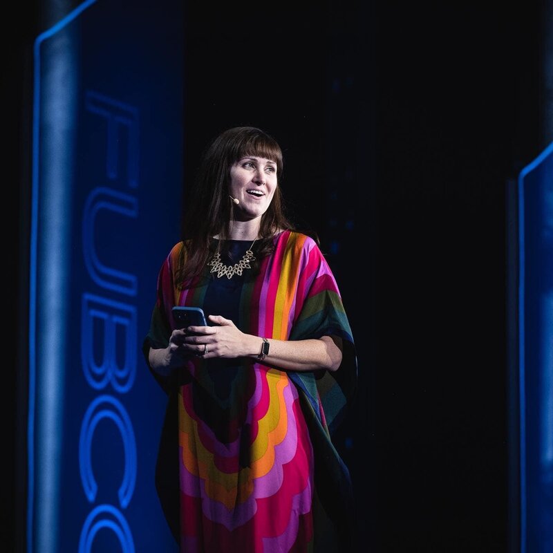 Close-up shot of Brittany Hodak speaking on stage  for FUBCON