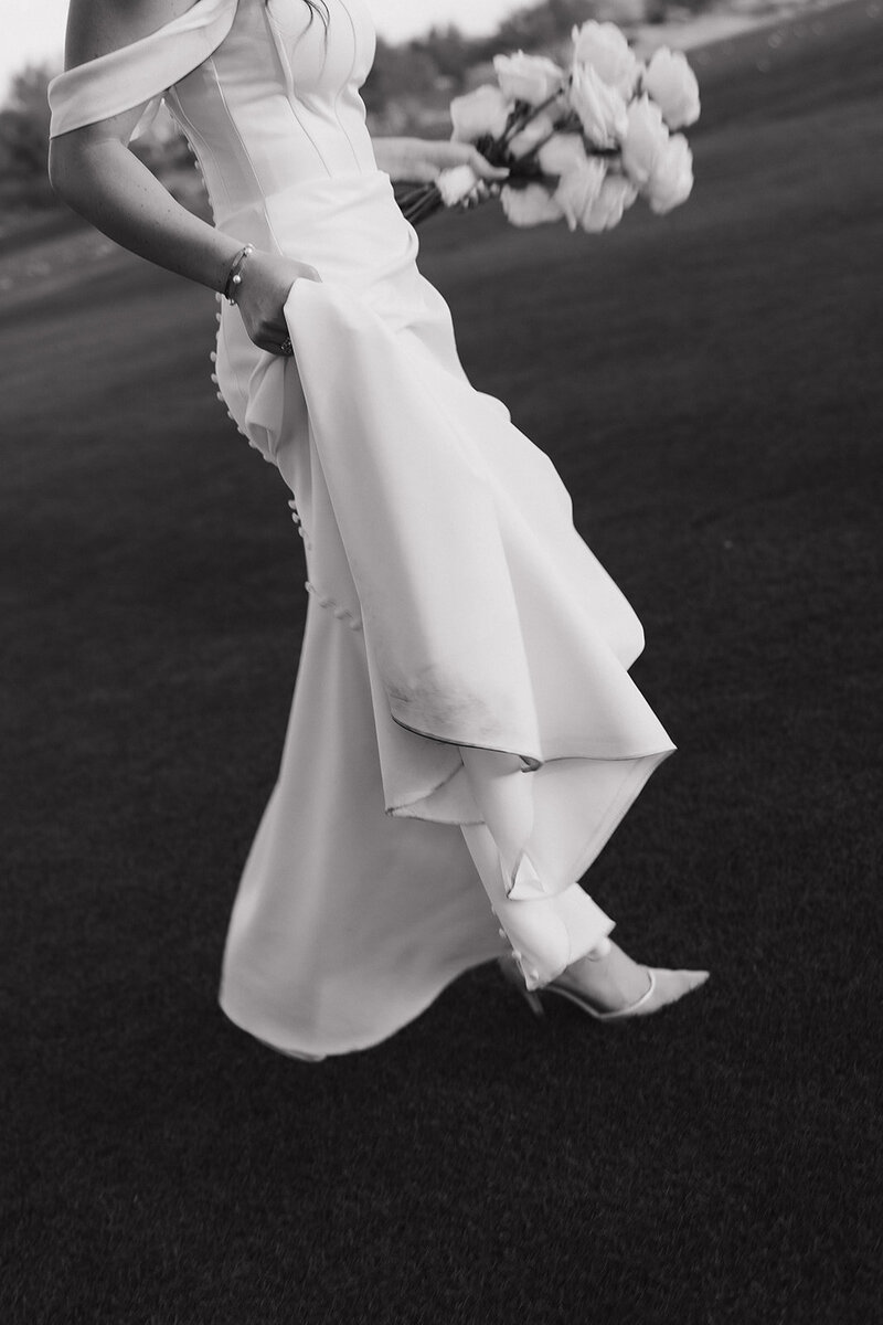 bride holding dress in arizona at intimate wedding