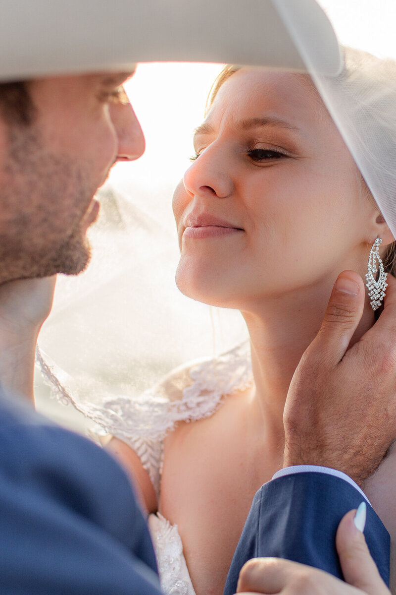 Bride and groom under Bald Head Island Lighthouse