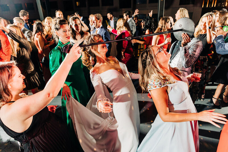 Guests dancing and having fun on a lively wedding dance floor, showcasing the playful, upbeat vibe of a wedding planned in Austin, Texas.
