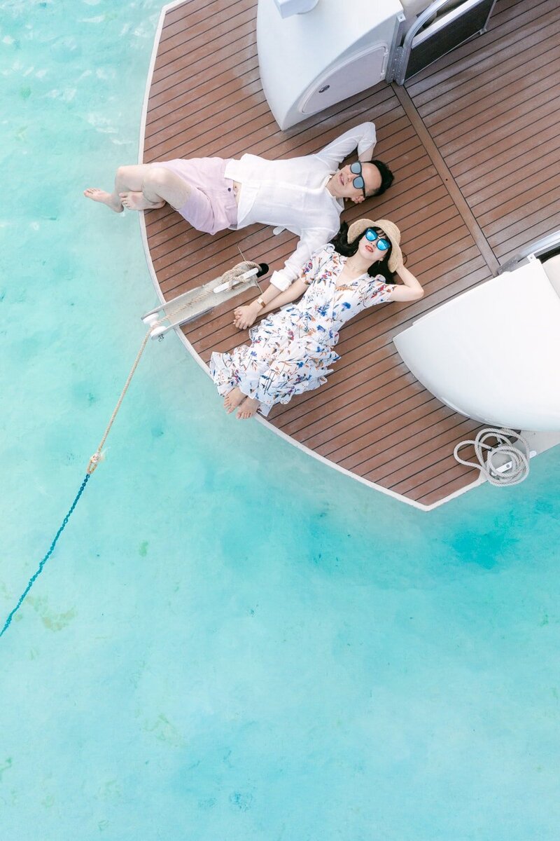 Intimate elopement Aerial Drone view on the couple relaxing on the boat
