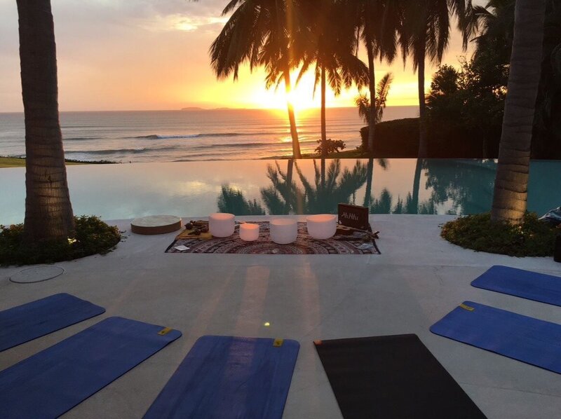 Natacha Radojevic leading a tranquil sunset sound bath by the pool in Sayulita, combining sound healing with nature for deep relaxation and energetic balance.