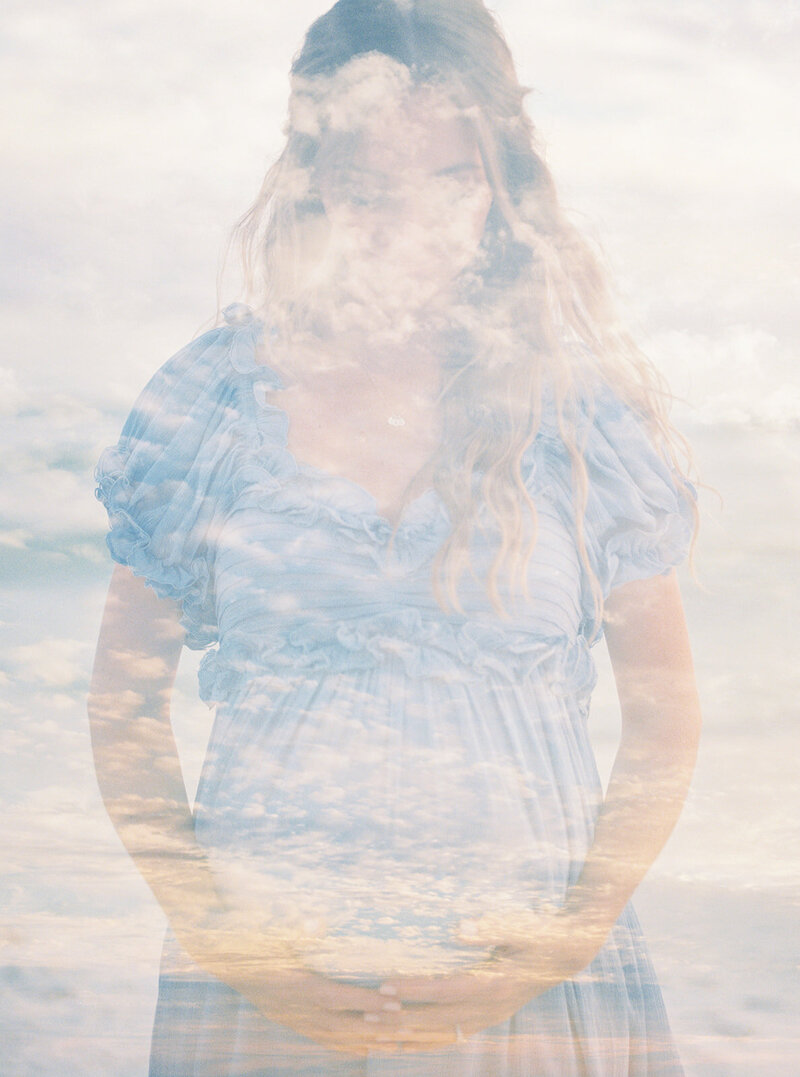 Double exposure of pregnant mother holding her belly while wearing a blue dress at the beach, photographed by Maryland Maternity Photographer Marie Elizabeth Photography