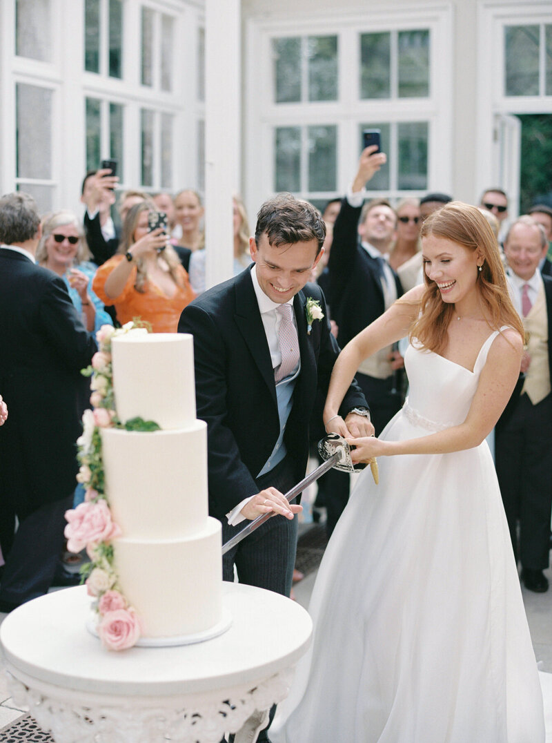 Bride and Groom Cutting Cake at Come House Domed Conservatory