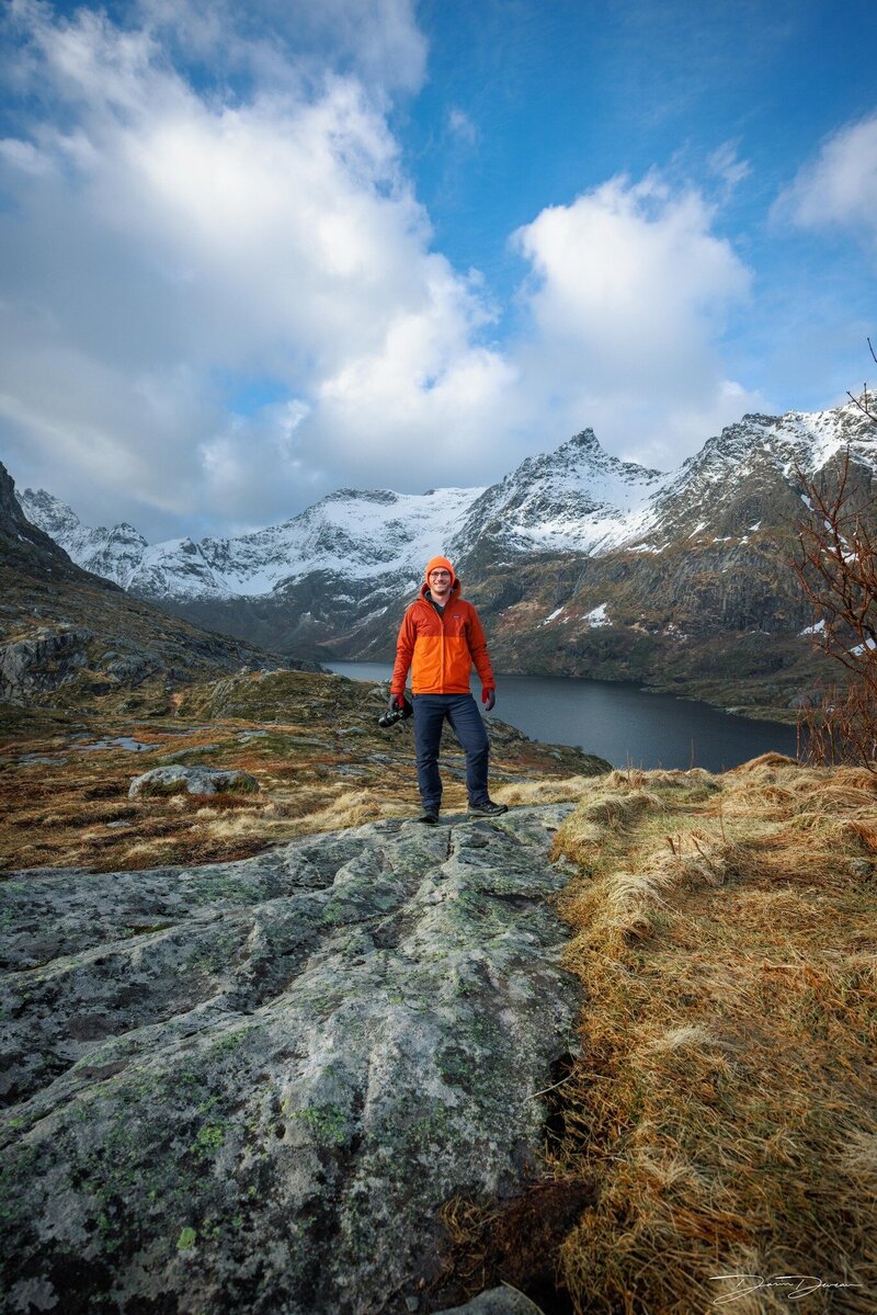 Peter Forister Landscape Photographer standing in a dramatic mountain range with a camera