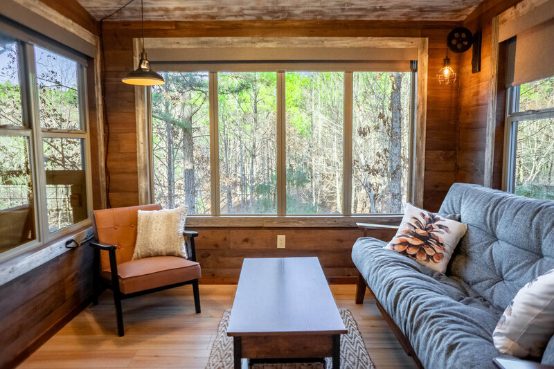 Inviting cabin bedroom with mountain views and reading nook