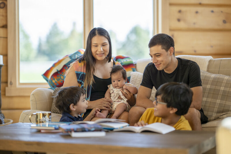 Indigenous family gathered close in living room