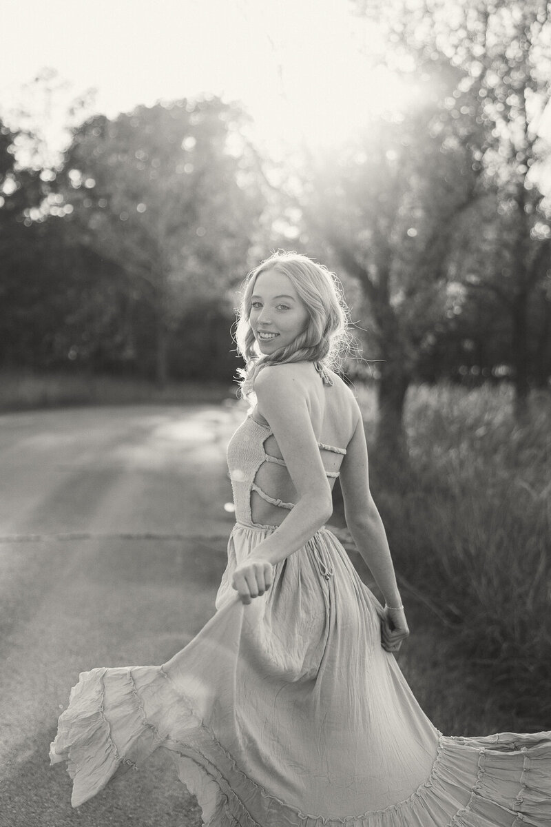 Senior girl in moody lighting with soft contrast. 