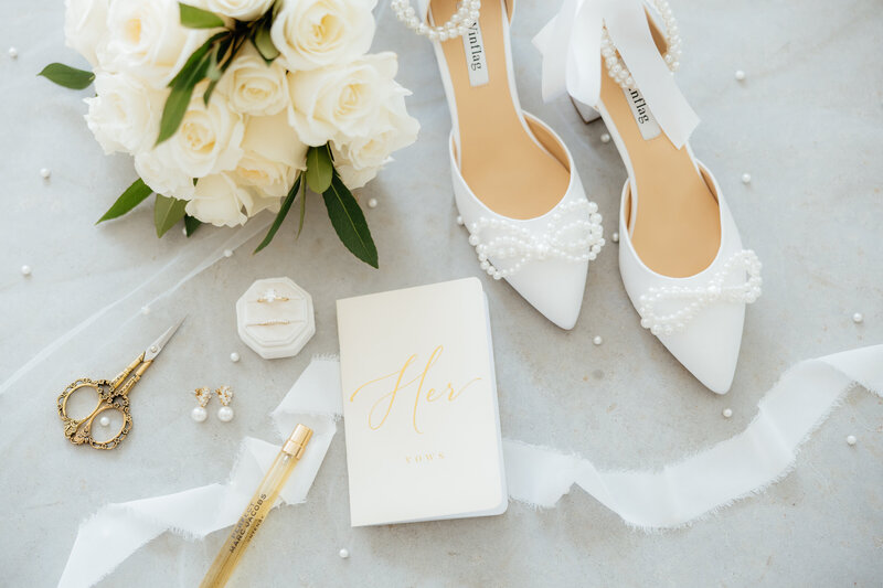 White and gold wedding details with pearls.