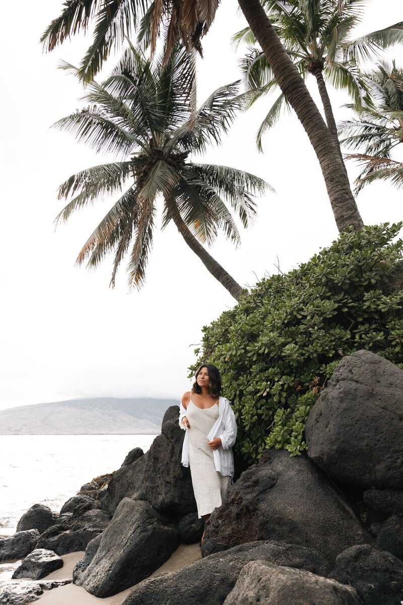 Amber is on the beach in Hawaii, holding an instant camera in her hands as she stares dreamily into the sunset (not pictured).