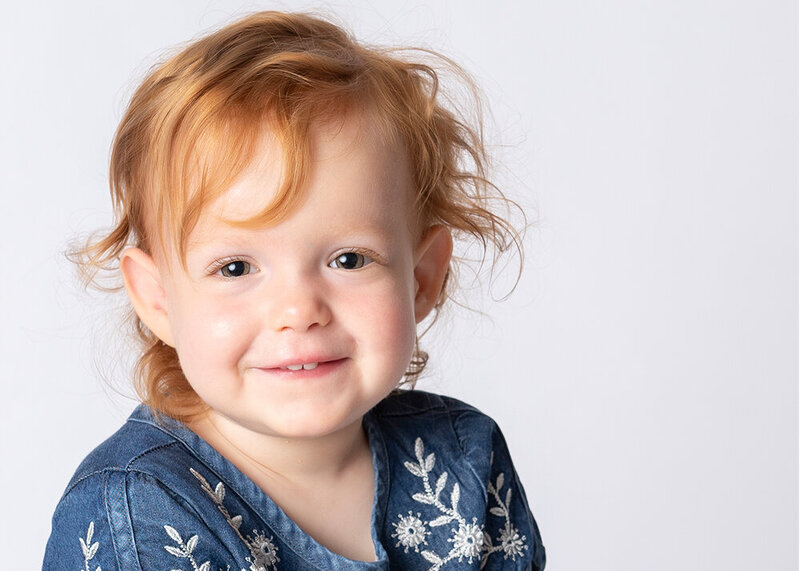 Young readheaded girl smiling