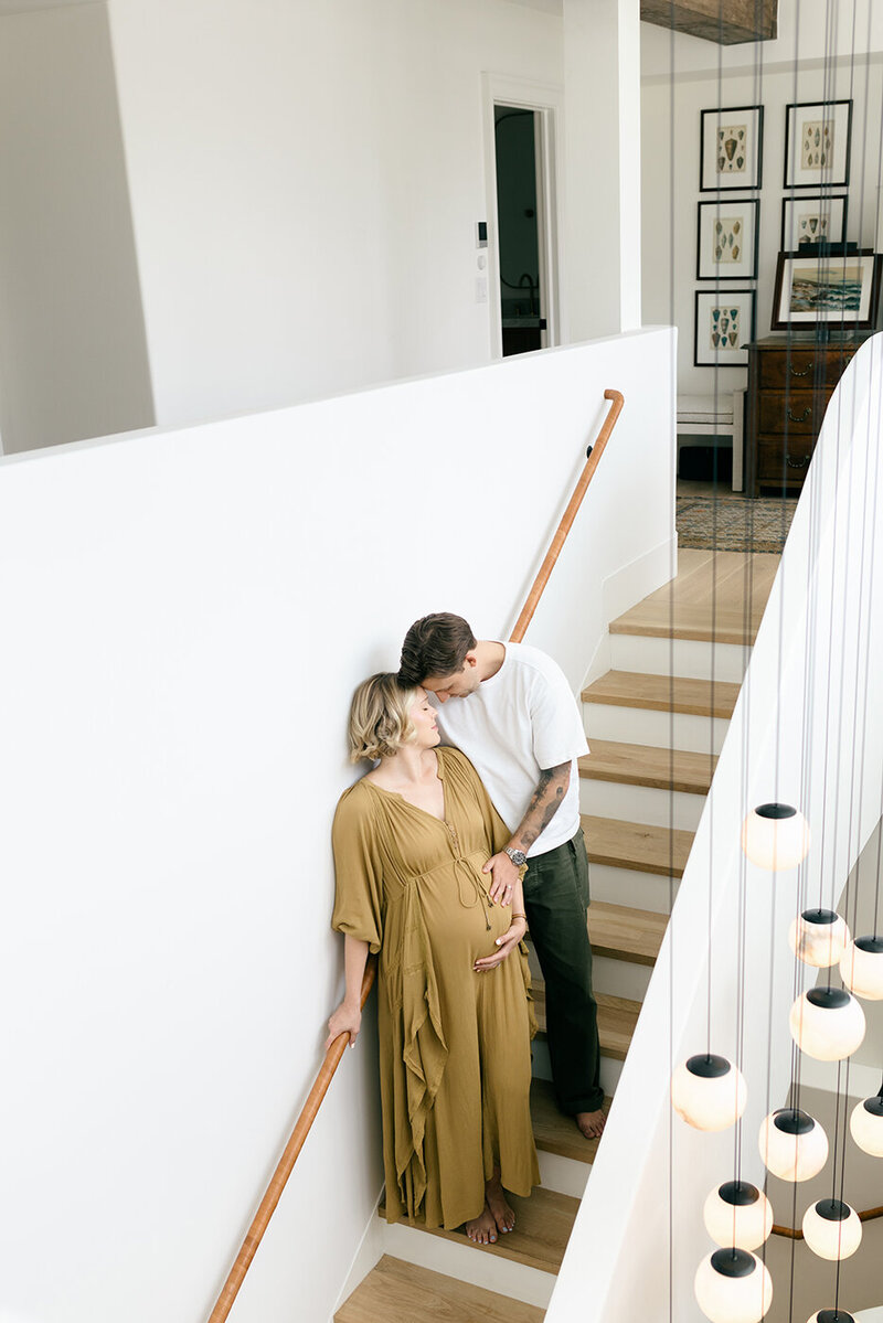 pregnant couple in the stairway, mom in yellow dress