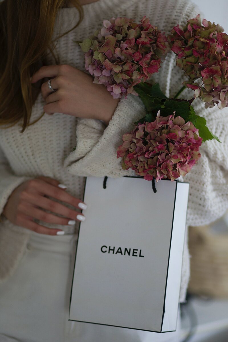 woman holding flowers and bag