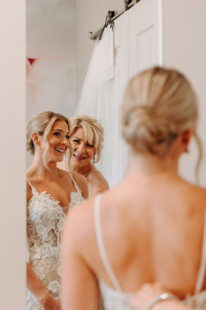 The reflection of a bride and her mother in a mirror