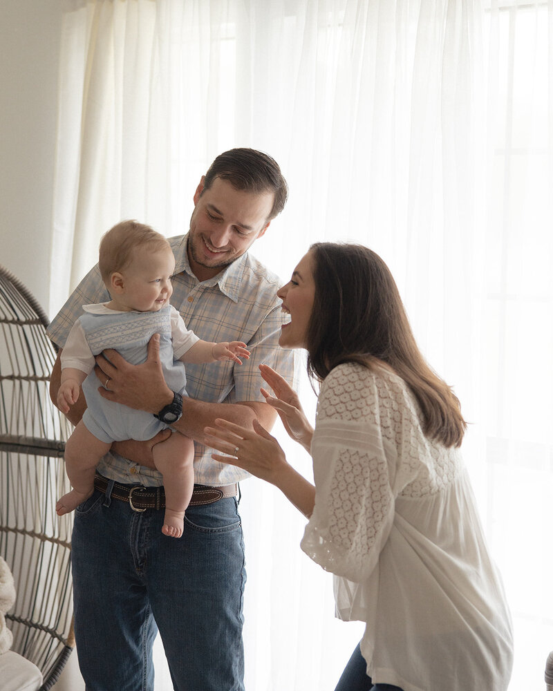 Indoor photo of family laughing near window