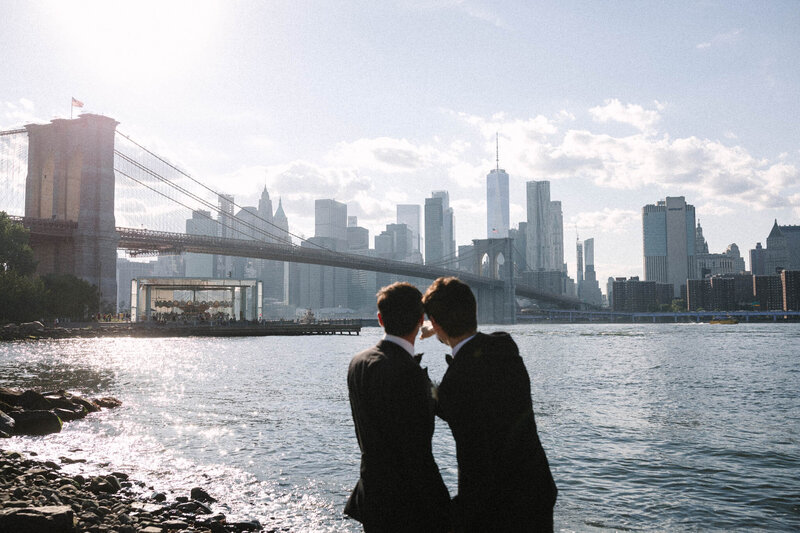 Brooklyn courthouse elopement two grooms in dumbo looking at brooklyn bridge jane carousel