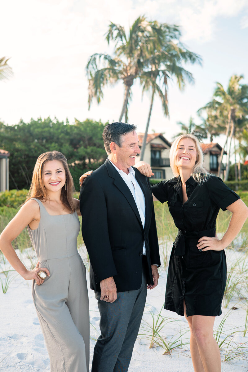 Real Estate team poses on beach for content creation photoshoot