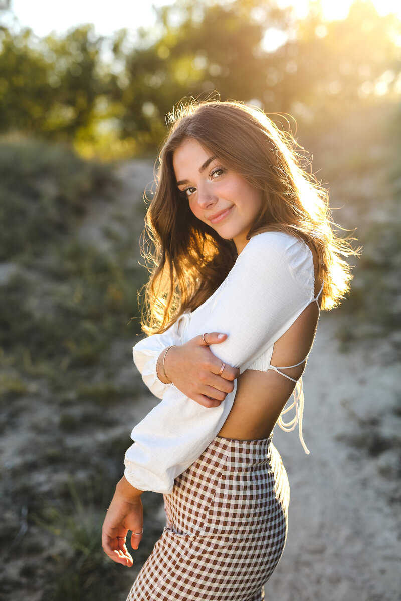 Gorgeous sunkissed senior girl in a natural location