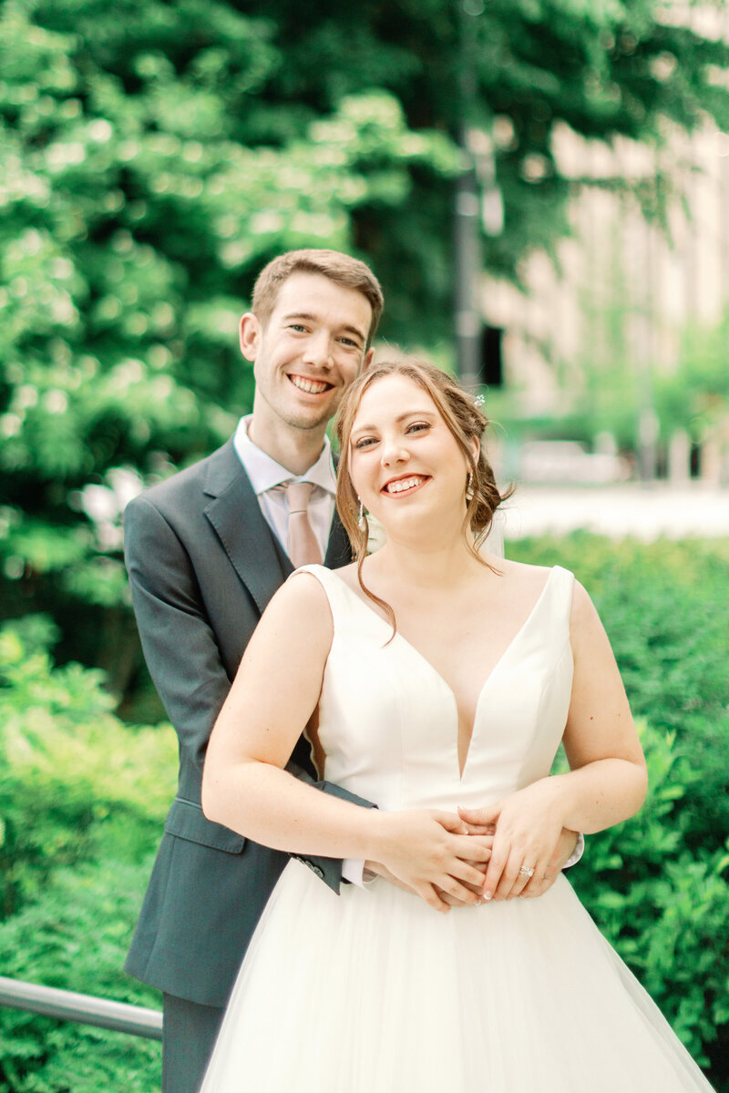 Groom Holding bride from behind at forest park st louis