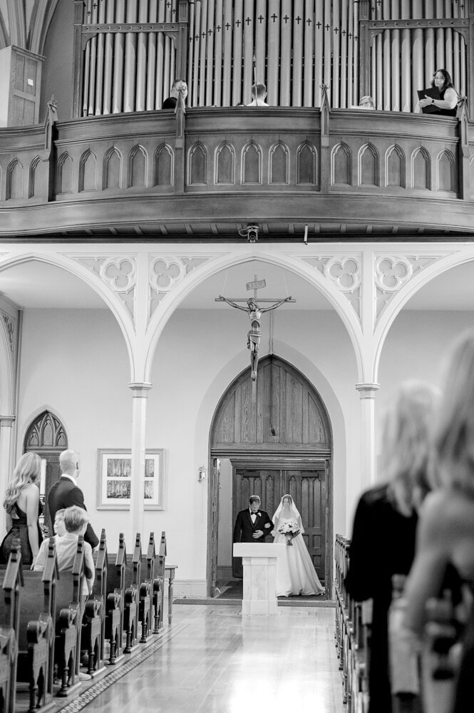 a bride and groom participating in a Catholic wedding ceremony