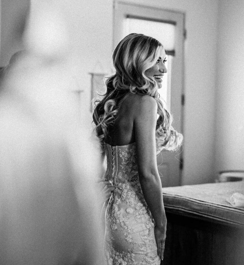 Bride on wedding day in Mimosa, a fitted lace wedding dress by Eva Lendel.