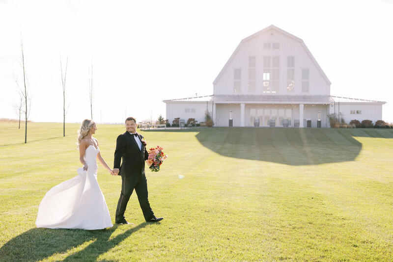 Outdoor wedding reception with flowers and candles by fireplace