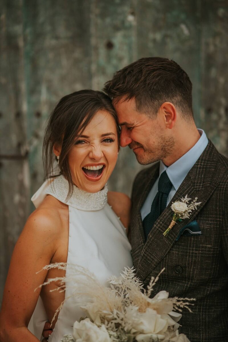 bride and groom laughing