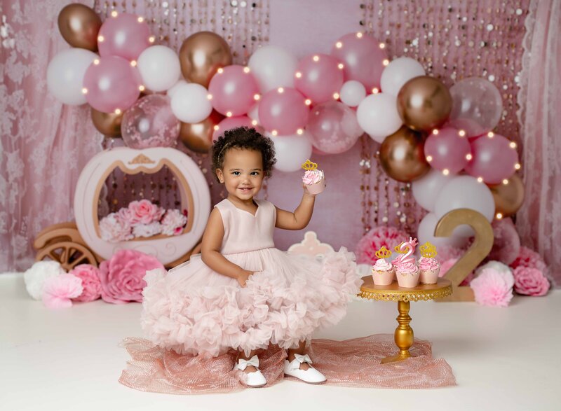 Boy and girl twins sitting on stool by #2 balloon filled marquee. Atlanta Children photography session was taken by Jenni Nikki Photography.