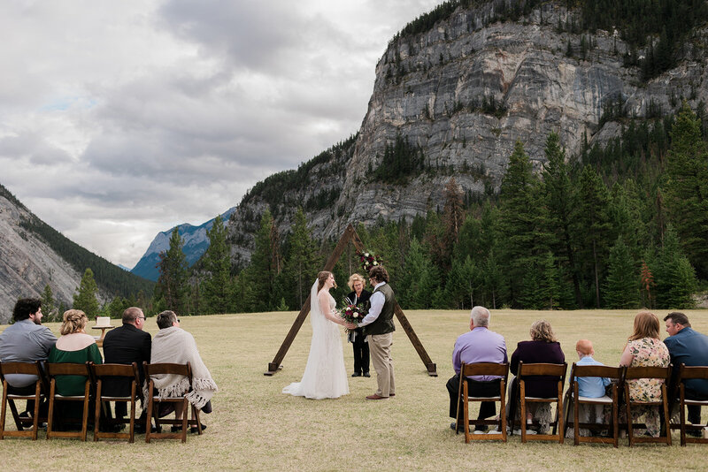 Couple saying vows in front of mountain