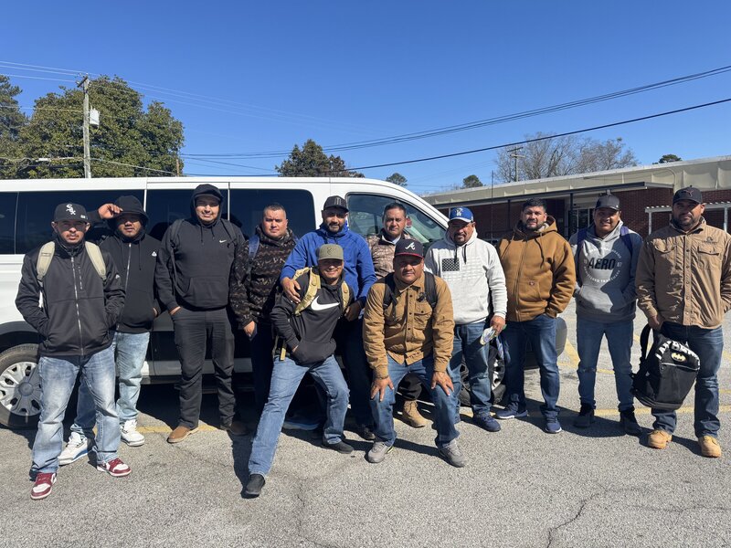 The crew gathered outside the van.