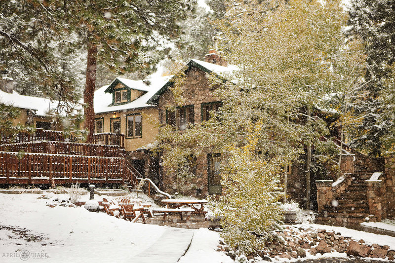 Exterior view of Meadow Creek Lodge & Event Center during October with fall color and snow