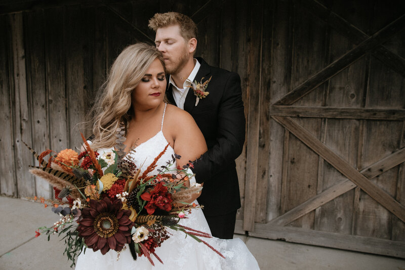 groom hugging bride  taken by fargo wedding photographer kiella lawrence