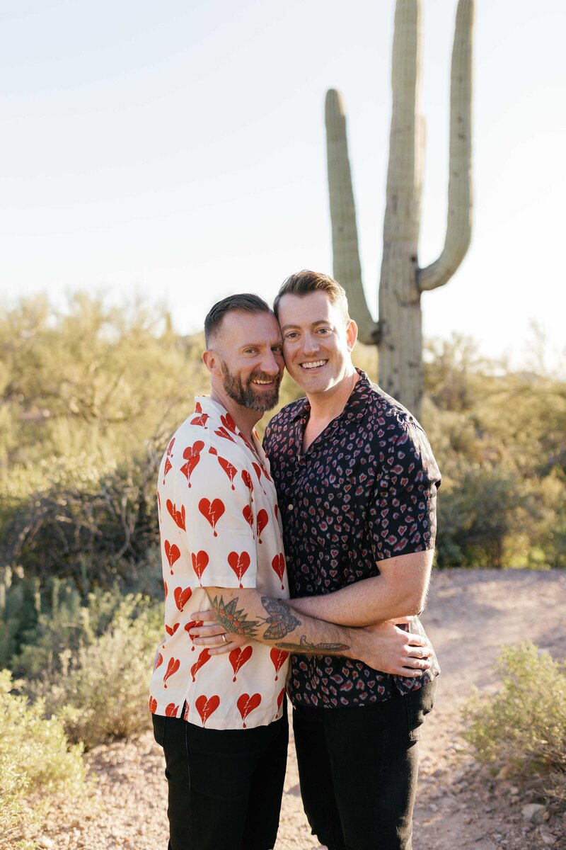 Couple hug and smile in the Arizona desert.