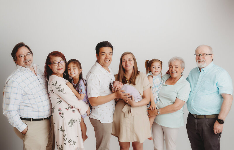 Extended Family poses together with Newborn Baby during Newborn Photography Session in Asheville, NC.