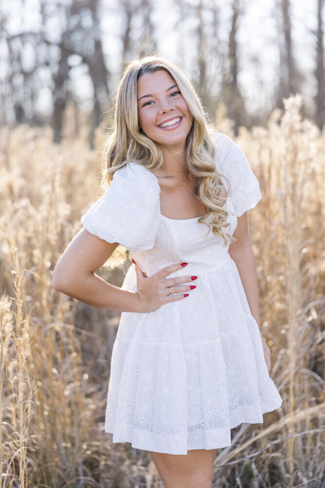 girl smiling in a dress with her hand on her hip