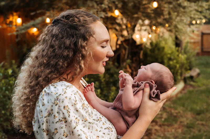 Charlotte family of four sharing sweet smiles and cuddles during a candid photography session.